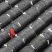 A worker checks on coils of steel at a factory in Dalian