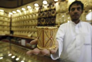 Mahdi al-Mehri, 28, saudi jeweller displays gold bangle in a jewellery shop at the surrounding area of the Grand Mosque during the annual haj pilgrimage in the holy city of Mecca