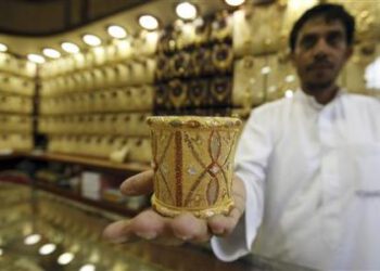 Mahdi al-Mehri, 28, saudi jeweller displays gold bangle in a jewellery shop at the surrounding area of the Grand Mosque during the annual haj pilgrimage in the holy city of Mecca