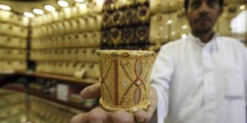 Mahdi al-Mehri, 28, saudi jeweller displays gold bangle in a jewellery shop at the surrounding area of the Grand Mosque during the annual haj pilgrimage in the holy city of Mecca