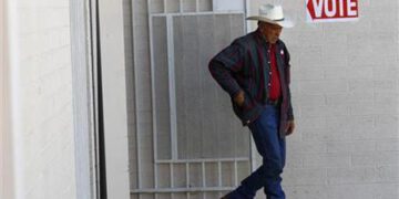 A voter exits a polling station after voting in Phoenix
