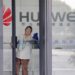 File photo shows a cleaner wiping the glass door of a Huawei office in Wuhan