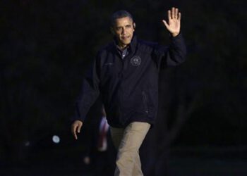 U.S. President Barack Obama waves as he returns to the White House in Washington