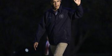U.S. President Barack Obama waves as he returns to the White House in Washington