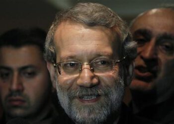 Iran's Parliament speaker Ali Larijani smiles after speaking to journalists at Beirut international airport