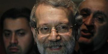 Iran's Parliament speaker Ali Larijani smiles after speaking to journalists at Beirut international airport