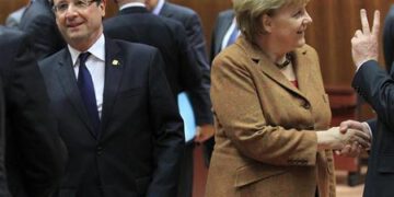 France's President Hollande walks past Germany's Chancellor Merkel during European Union leaders summit in Brussels