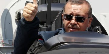 Turkish Prime Minister Tayyip Erdogan gives a thumbs-up sign from the cockpit of the Turkish Primary and Basic Trainer Aircraft "Hurkus" during a ceremony at the Turkish Aerospace Industries in Ankara