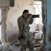 Extreme tourist Toshifumi Fujimoto takes pictures in Aleppo.
