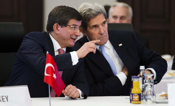 U.S. Secretary of State Kerry talks with Turkish Foreign Minister Davutoglu during a "Friends of Syria" group meeting in Istanbul