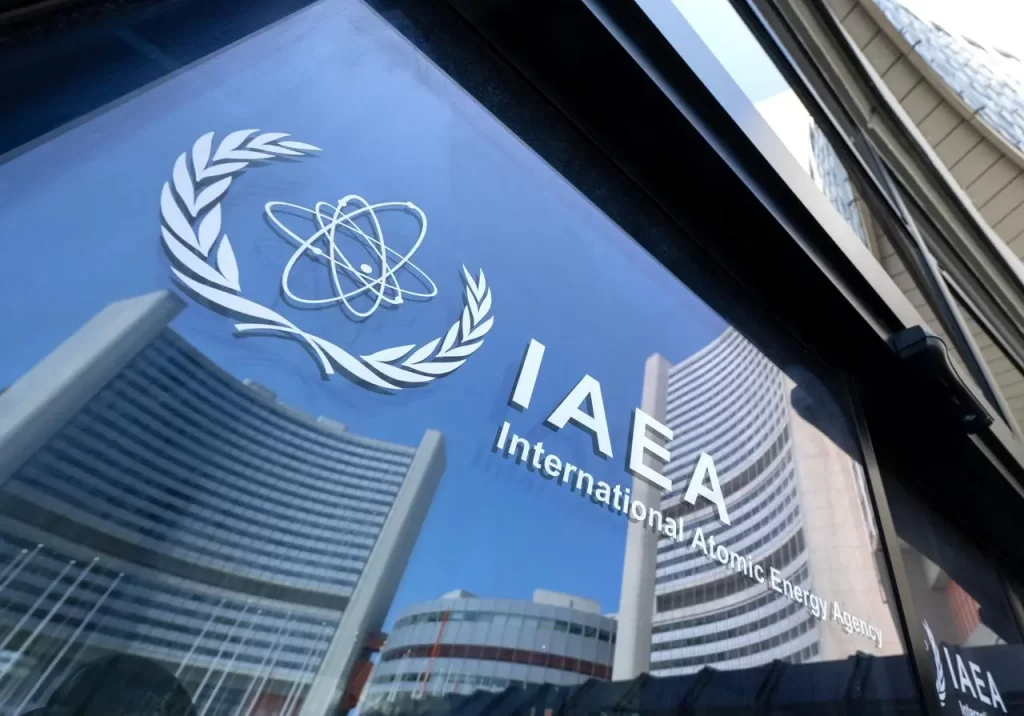 Reflections of the IAEA headquarters buildings are seen through glass doors bearing the agency's logo during the Board of Governors meeting in Vienna, Austria, on June 13, 2025. (AFP Photo)